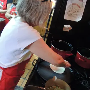 Baking  corn tortillas on a comal.