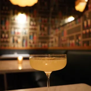 a cocktail in a coupe glass on a table