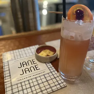 a drink with a garnish garnish