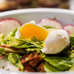 a bowl of salad with an egg