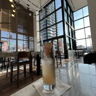 a cocktail in a tall glass on a table