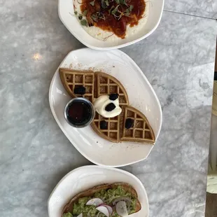 three plates of food on a marble table