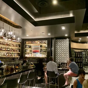 a group of people sitting at a bar