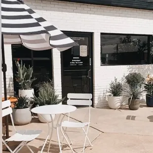 a patio with tables and chairs