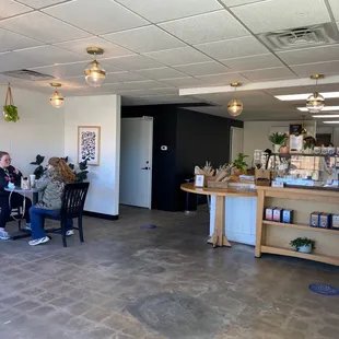 people sitting at tables in a coffee shop
