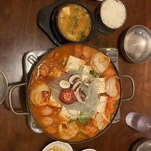 Kimchi and dumpling hotpot (center); Mackerel and soybean paste stew combo (top).