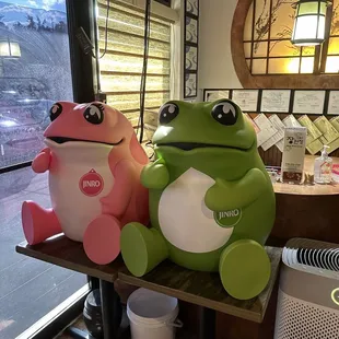 a frog and a froggy sitting on a table