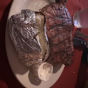 a steak and potatoes on a plate