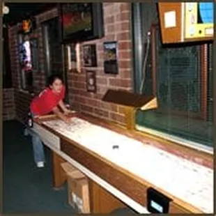 a woman playing a shuffle table