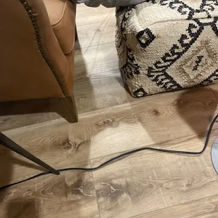 a person sitting on a couch with their feet on the floor