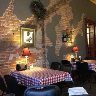 a dining room with a brick wall