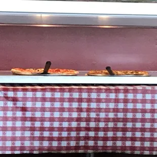 Two lonely pizzas for a buffet.