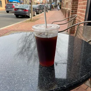 Sitting at one of the outdoor tables.