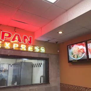 a neon sign above the counter