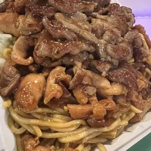 a plate of noodles with meat and vegetables