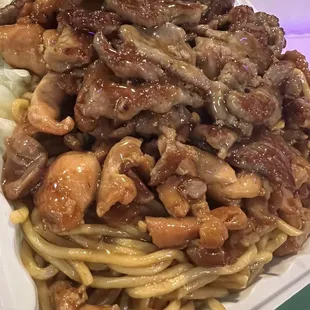 a plate of noodles with meat and vegetables