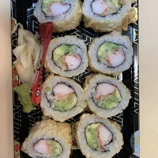 a plate of sushi rolls