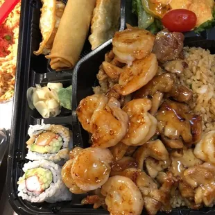 Bento box chicken and shrimp with garden salad, 4 piece California roll, 2 piece chicken dumplings and 1 piece spring roll