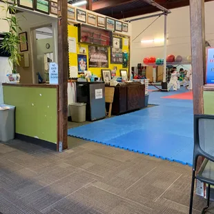 Office, fridge to purchase drinks, and photo wall.