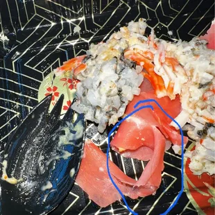 a plate of sushi and vegetables