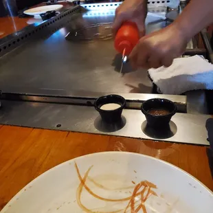  person preparing food on a grill