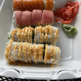 a tray of sushi with a variety of toppings