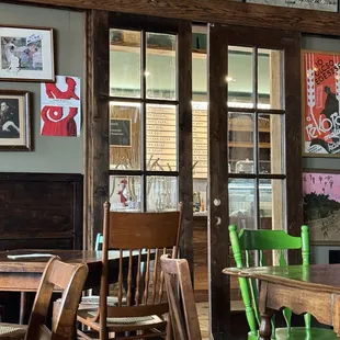 A variety of wooden furniture by a door to a connected bakery