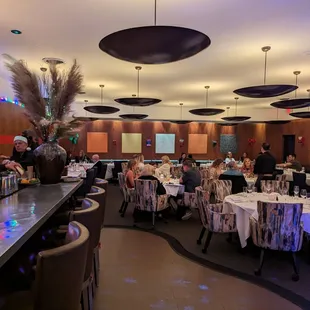 people sitting at tables in a restaurant