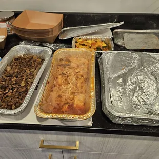 Carne asada &amp; chicken tinga 1/4 pans + tortilla shells. The small tin in the back is squash, mushrooms, and corn for veggie tacos.