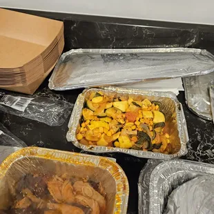 a variety of containers of food on a table