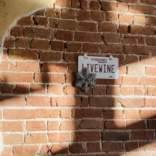 a sign on a brick wall