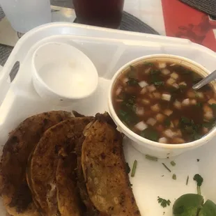 a bowl of soup and three tortillas