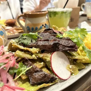 Chilaquiles verdes de guacamole con skirt steak! Big delicious portion = Food coma / happiness!
