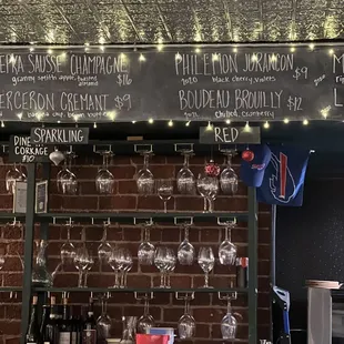 a bar with wine glasses on the counter