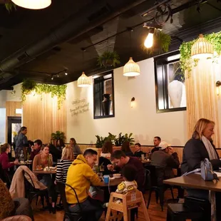 people sitting at tables in a restaurant