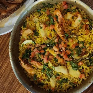 a bowl of rice with shrimp and vegetables