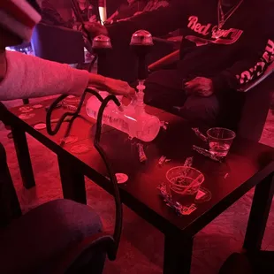 a man sitting in a chair with a hookah