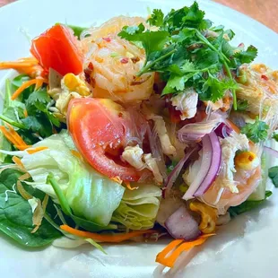 Yum Woon Sen salad is perfectly layered with lettuce,warm rice noodles, prawns, chicken, and tomato. Dressed in a tasty fish and lime sauce!