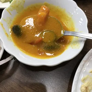 a bowl of soup and a plate of salad