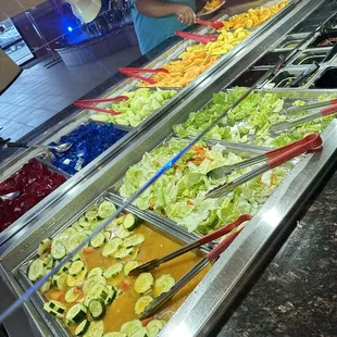a salad bar with a variety of salads