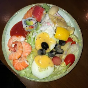 Shrimp, salad, sushi and crab salad.