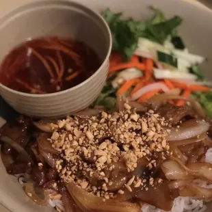 a bowl of noodles with meat and vegetables