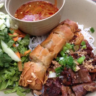 Amazing noodle salad with meat and egg roll. Crisped to perfection with a perfectly spiced sauce and fresh veggies.