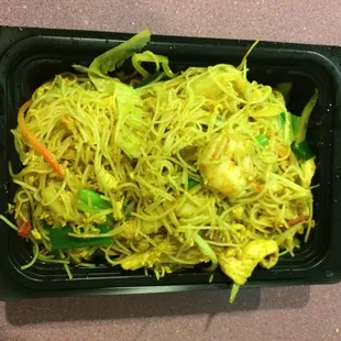 a tray of noodles with shrimp and vegetables