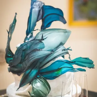 a cake with blue and green flowers