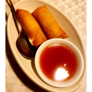 a plate of food with a spoon and sauce