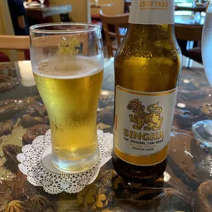 a glass of beer and a bottle of beer