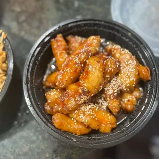 a bowl of chicken wings and a bowl of rice