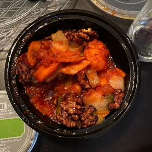 a bowl of stew and a glass of water