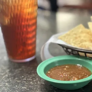 a plate of tortillas and a bowl of salsa